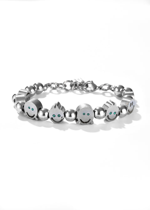 A happy face bracelet in cute face charms, each with green colored gemstones eyes.