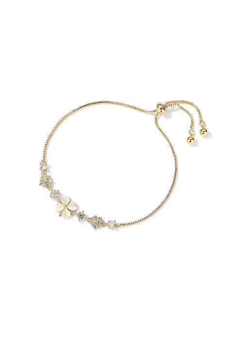 A gold clover bracelet with an adjustable chain surrounded by sparkling crystals.