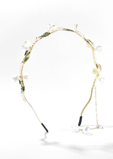A flower headband with floral details and small white pearls.