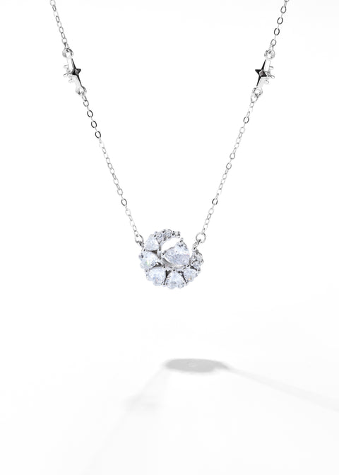 A crescent moon necklace featuring a delicate chain with clustered sparkling stones.
