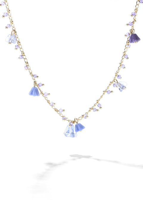 A flower necklace with small lavender beads and larger blue flower-shaped pendants.