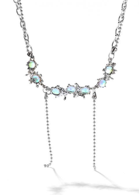 Dangle necklace with a silver chain and a row of small, shiny blue opal stones set.