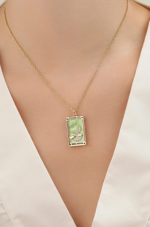 A tarot card necklace featuring a rectangular pendant inscribed at the bottom.