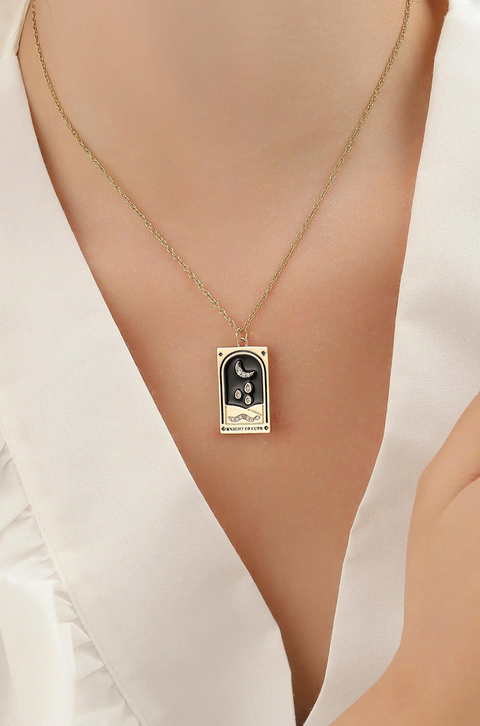 A tarot card necklace featuring a rectangular pendant inscribed at the bottom.
