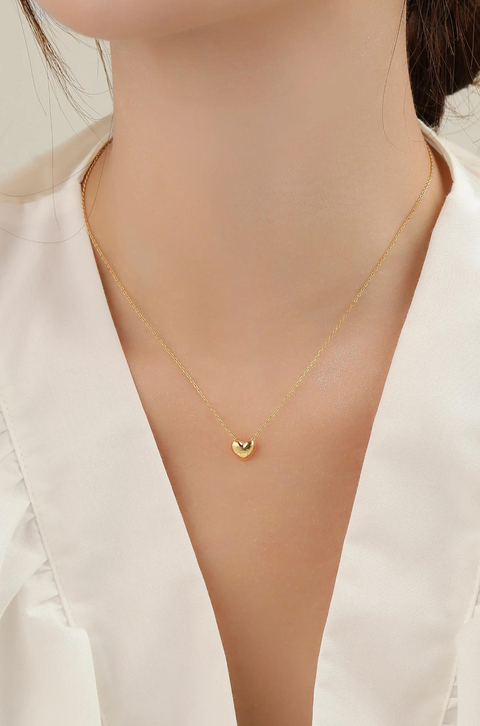 A simple gold heart pendant on a delicate chain.