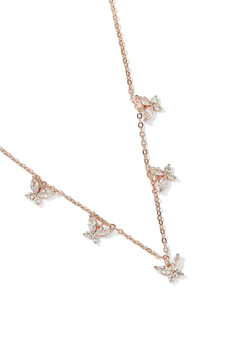 A crystal butterfly necklace with butterfly pendants set on a chain.