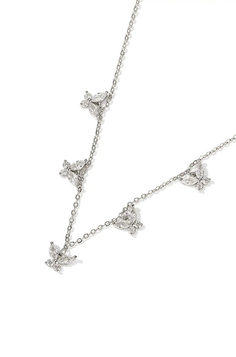 A crystal butterfly necklace with butterfly pendants set on a chain.