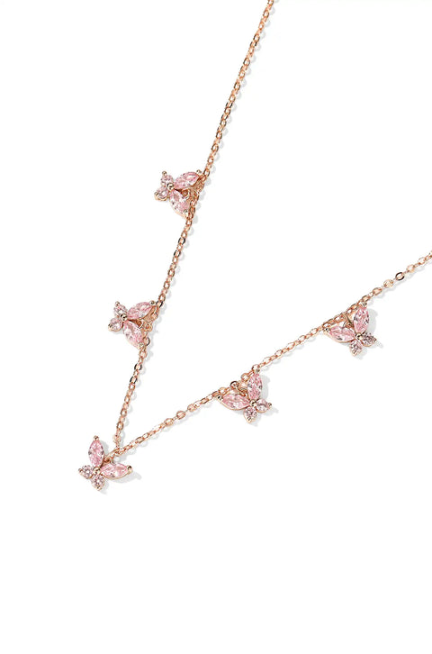 A crystal butterfly necklace with butterfly pendants set on a chain.