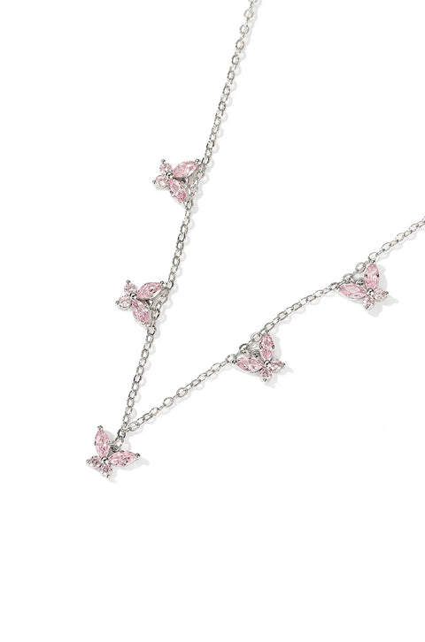 A crystal butterfly necklace with butterfly pendants set on a chain.