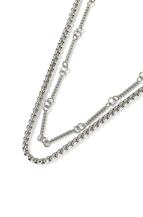 A two layer chain necklace with one chain having a smooth design and the other with detailed, textured pattern.