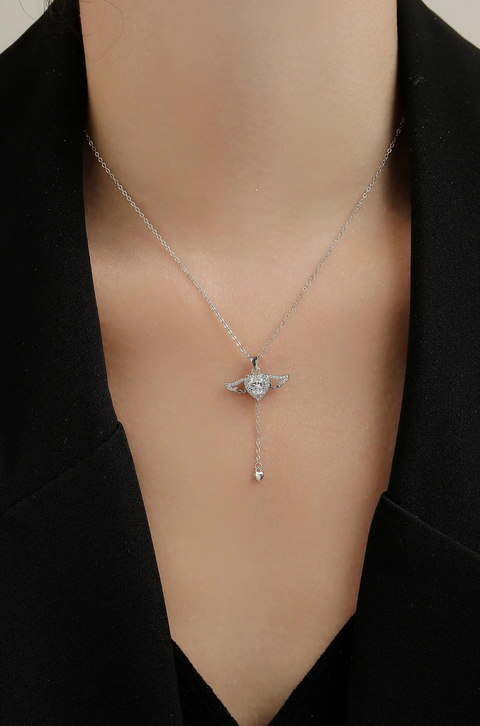 A winged heart necklace with a central crystal.