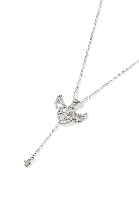 A winged heart necklace with a central crystal.