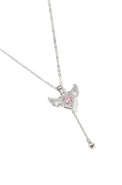 A winged heart necklace with a central crystal.