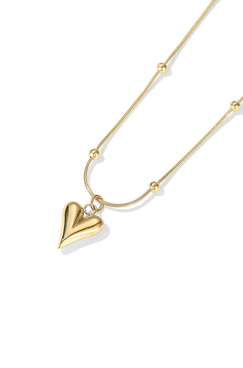 This heart bead necklace features a gold heart pendant hanging from a delicate chain with beads.