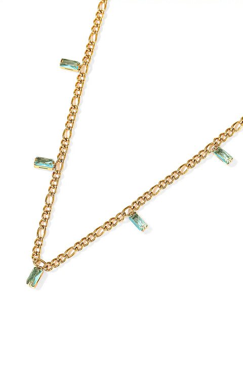 A gold baguette necklace featuring small rectangular aqua-colored crystals along the chain.