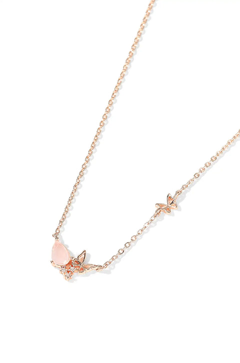 Pink butterfly necklace with small butterfly charms and strawberry pendant.