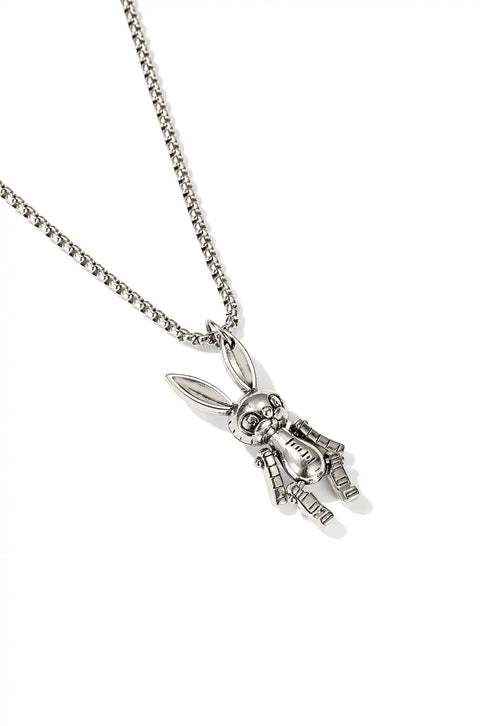 A bunny necklace with a metallic, robot-like pendant hanging from a chain.