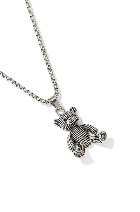 A silver teddy bear necklace with a striped texture, hanging from a sturdy link chain.
