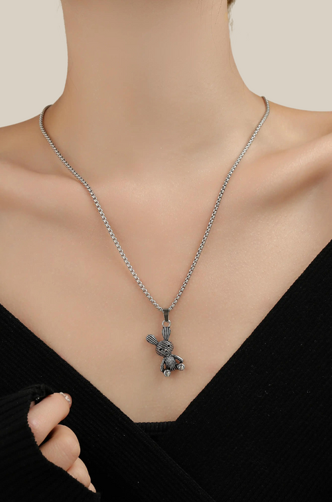 A care bear necklace with a silver chain and a detailed bunny pendant.