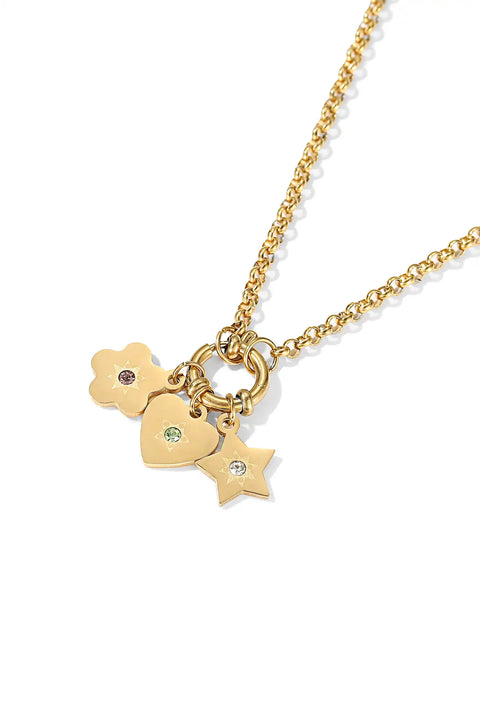 A cosmic cluster necklace featuring a mix of charms including a heart, a star, and a flower.