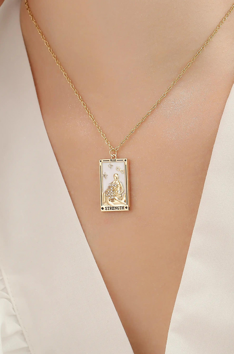 A tarot card necklace featuring a rectangular pendant inscribed at the bottom.