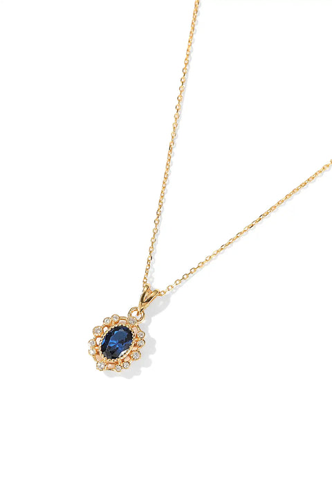This blue stone necklace has a pendant showcasing a deep blue gem surrounded by small crystals.