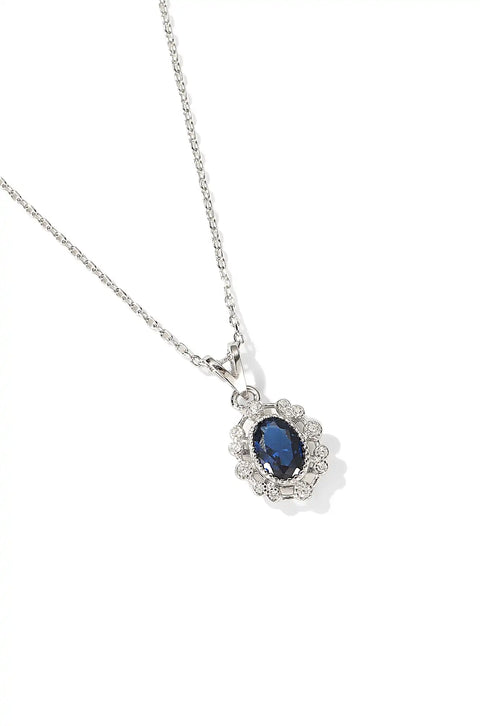 This blue stone necklace has a pendant showcasing a deep blue gem surrounded by small crystals.