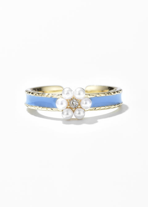 A Belle Inspired Princess Ring with a blue enamel band and a central floral design made up of small white pearls.