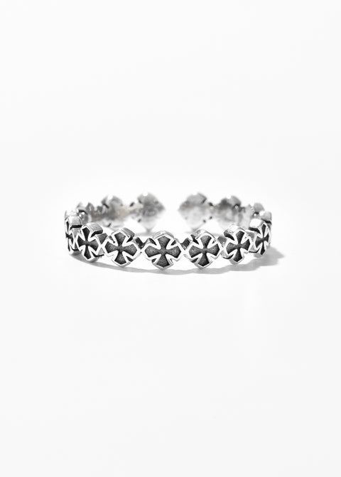 A silver band cross ring with a row of small, symmetrical design.