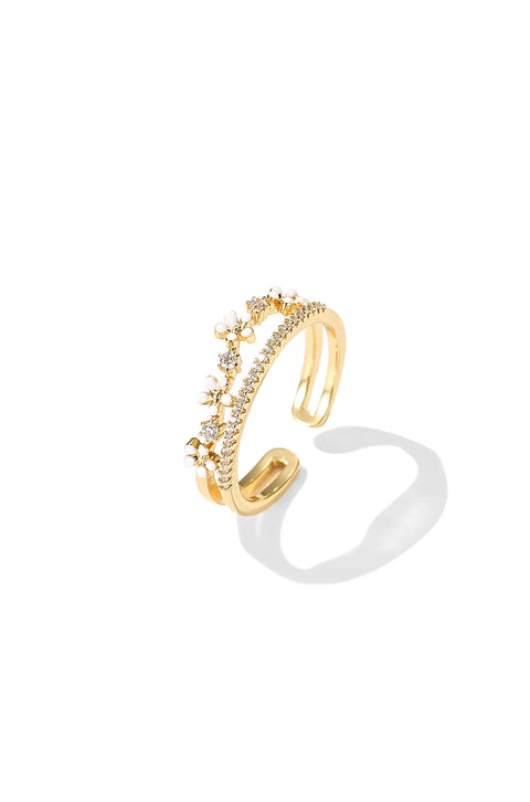 A flower gold ring with open design featuring small floral accents and sparkling stones.