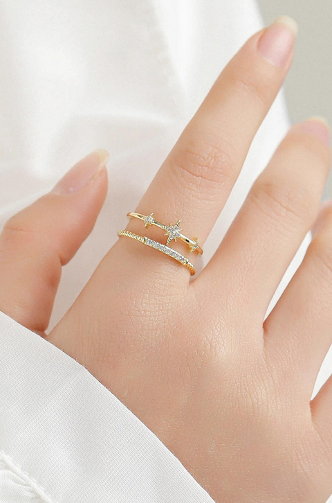 A gold open-ended star ring featuring three star embellishments.