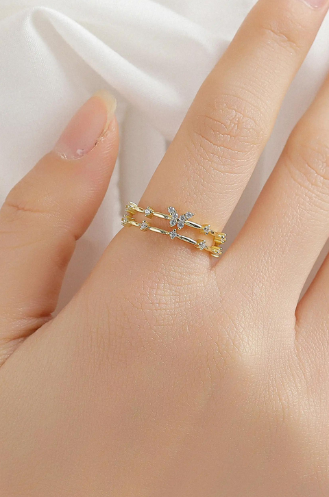 A sterling silver butterfly ring with butterfly motif accented by small stones.