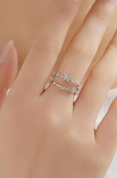 A sterling silver butterfly ring with butterfly motif accented by small stones.