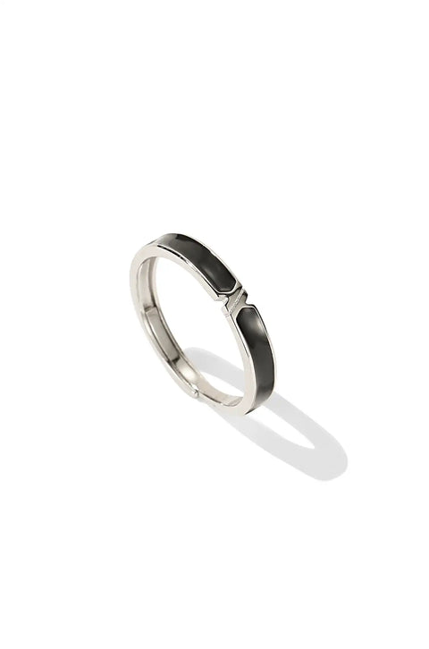 A yin yang ring set consisting of two thin, silver bands with a black-and-white yin yang symbol.