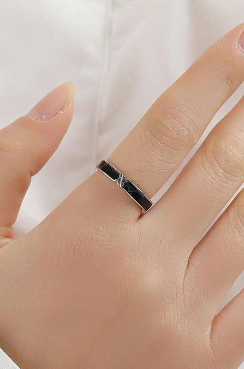 A yin yang ring set consisting of two thin, silver bands with a black-and-white yin yang symbol.