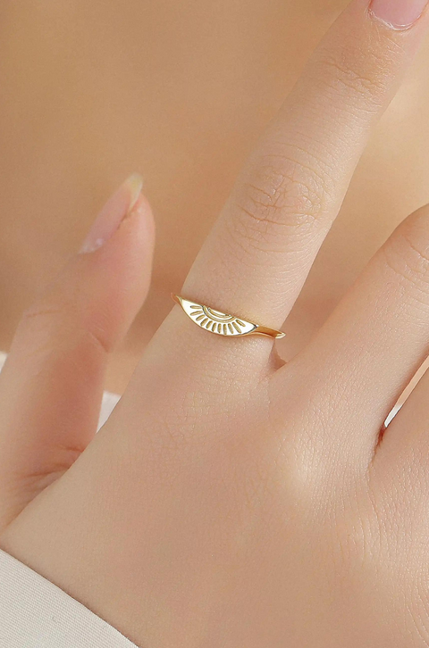 Couples rings, one in gold and one in silver, featuring sun/moon designs engraved.