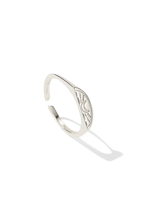 Couples rings, one in gold and one in silver, featuring sun/moon designs engraved.