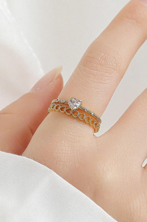 Heart infinite ring with looping infinity symbol band that cradles a heart-shaped stone at its center.