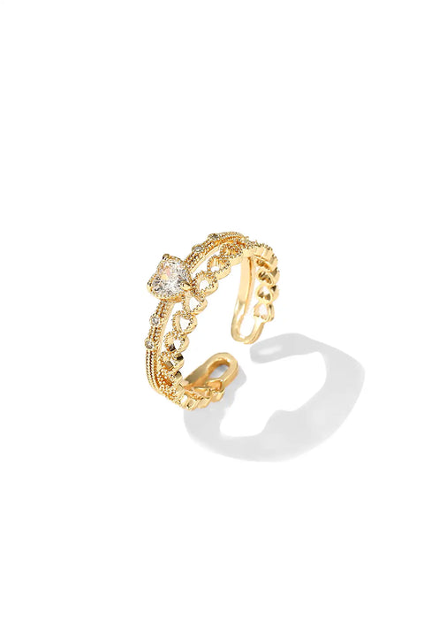 Heart infinite ring with looping infinity symbol band that cradles a heart-shaped stone at its center.