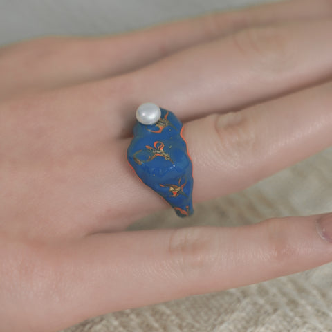 Artisan Rings accented by swirls and gold embellishments.