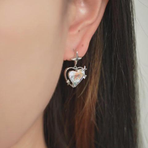 Puffed Heart earrings featuring reflective clear crystal and small star accents.