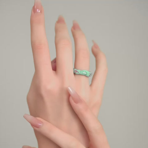 A wavy-shaped unique ring with a glossy finish, a statement ring accented by swirls and gold embellishments.