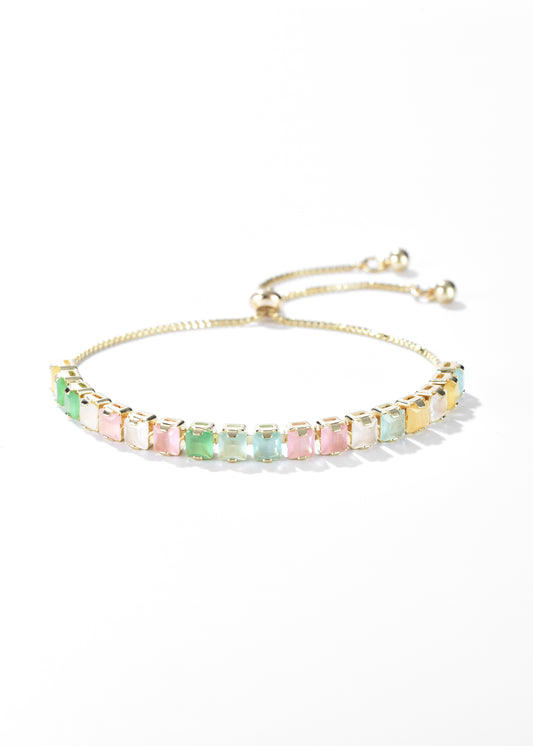 A golden bracelet with pastel-colored, square-cut stones, and has an adjustable clasp.