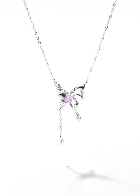 A butterfly necklace that has a small, pink gemstone at its center, all hanging on a sterling silver pendant necklace.