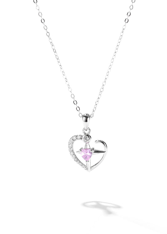 One of the matching couples necklaces with a silver cross pendant that has a smaller pink stone in the center and part of the heart outlined with tiny crystals.