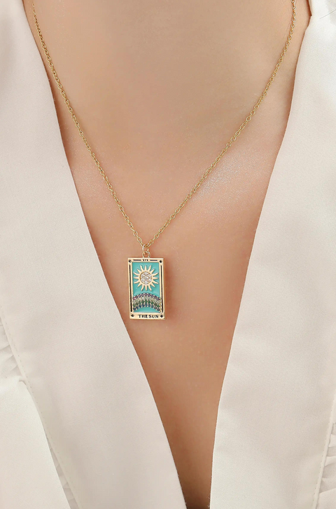 A tarot card necklace featuring a rectangular pendant inscribed at the bottom.