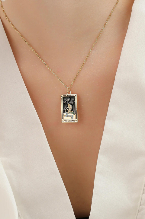 A tarot card necklace featuring a rectangular pendant inscribed at the bottom.