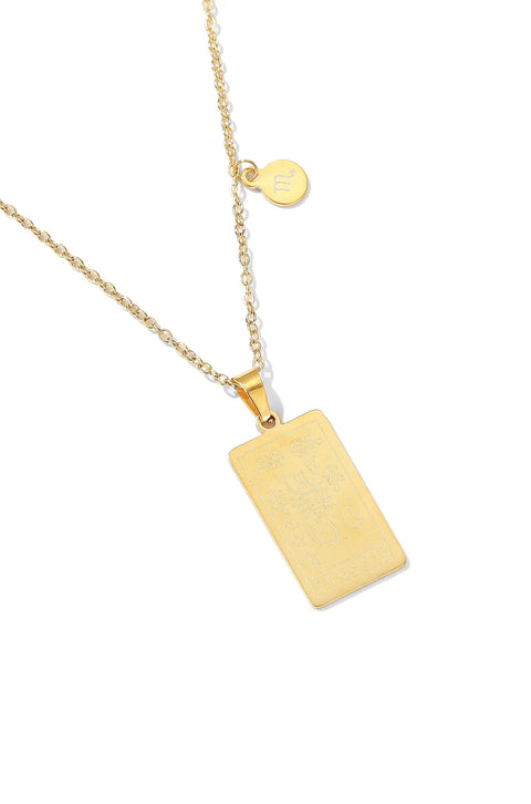 A Scorpio necklace featuring rectangular pendant with floral design, and a smaller, round charm with the zodiac sign.