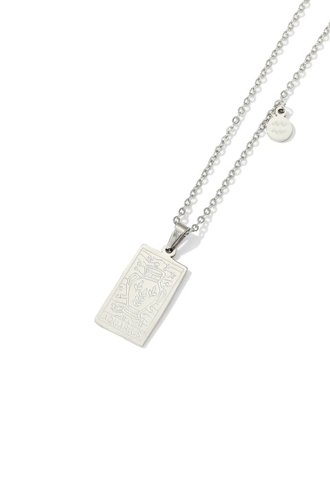 An Aquarius necklace featuring rectangular pendant with floral design, and a smaller, round charm with the zodiac sign.