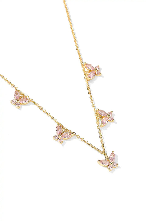 A crystal butterfly necklace with butterfly pendants set on a chain.